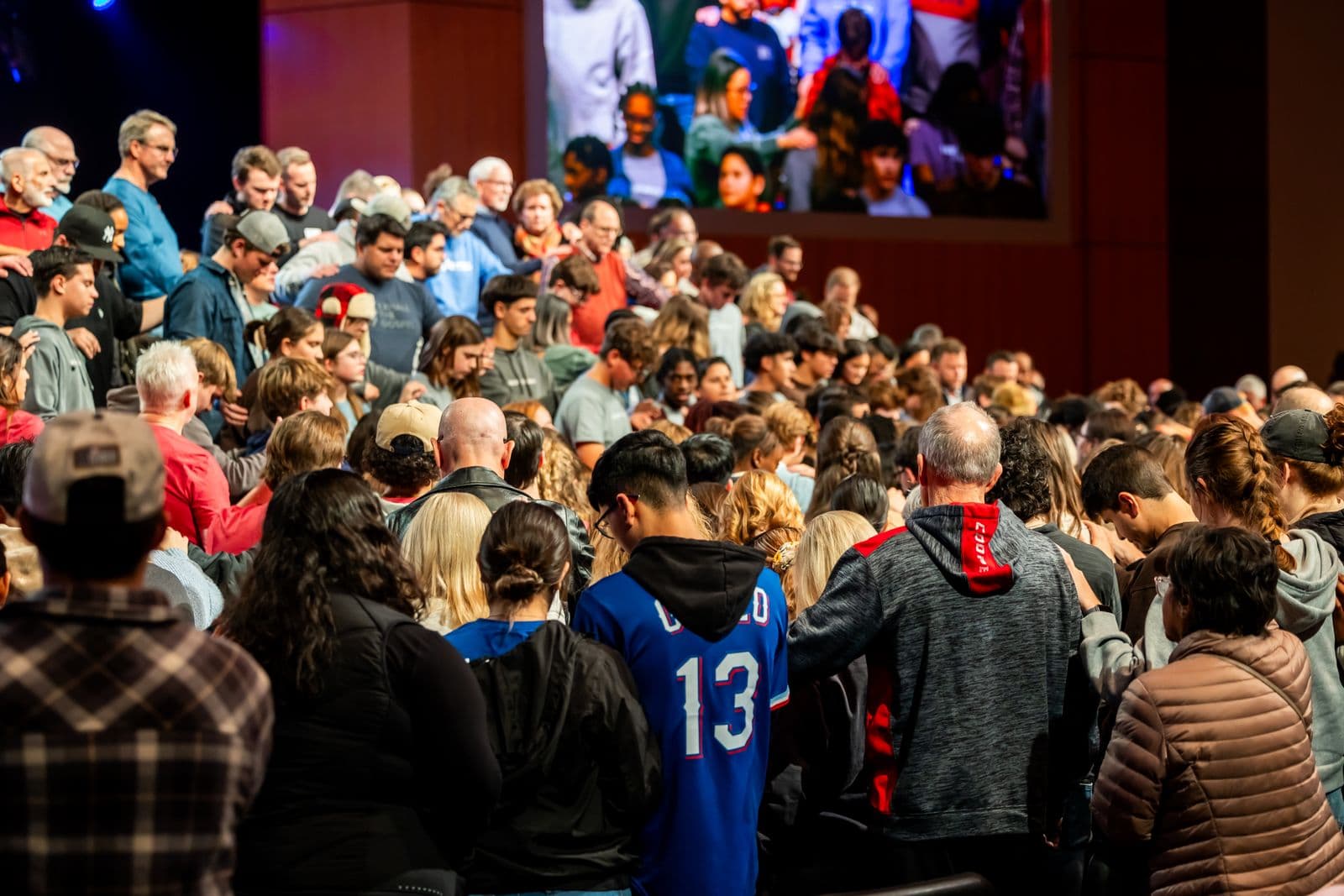 A diverse crowd gathered indoors for a community event